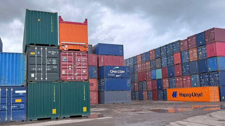 A wall of stacked shipping containers